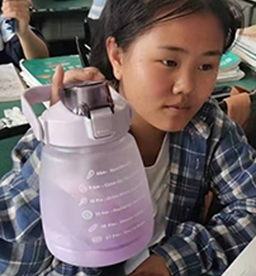 Grateful student showing new drinkware