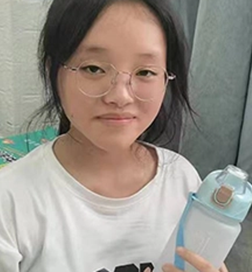 Student smiling with donated water bottle